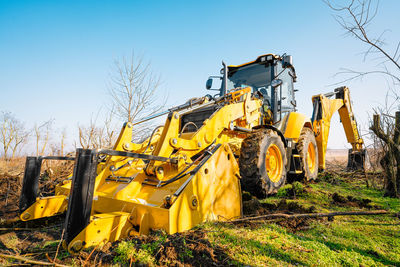 Bulldozer on land in spring