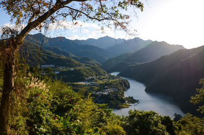 Scenic view of river and mountains against clear sky