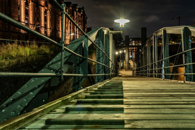 View of bridge over canal at night