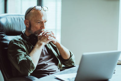 Young man using laptop at home