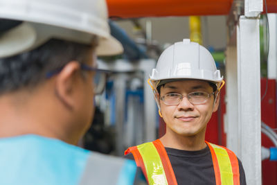 Close-up of male engineers discussing in factory