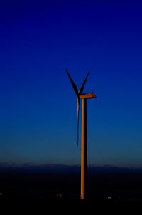 Windmills against clear blue sky