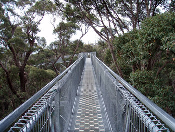 Footbridge against trees