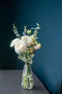 Beautiful ranunculus flowers on blue background with frame mock up