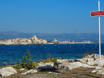Scenic view of sea against clear blue sky
