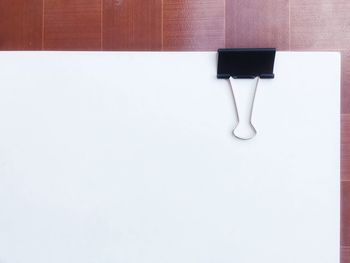 Low section of woman standing on white table