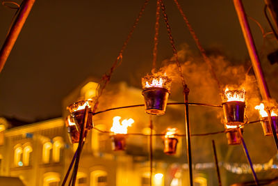 Low angle view of illuminated lighting equipment