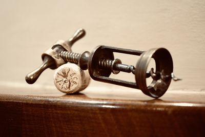 Close-up of machine on table against wall