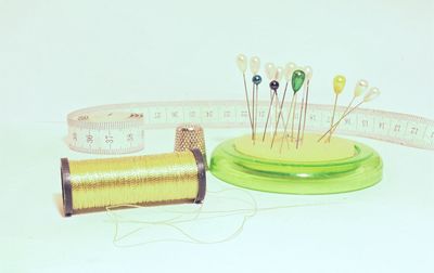 Close-up of sewing kit on white background