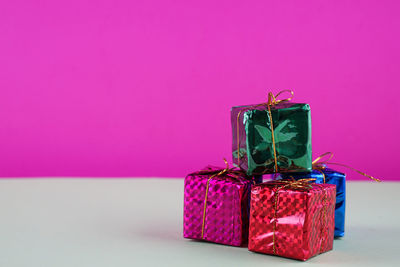 Close-up of christmas presents against yellow background