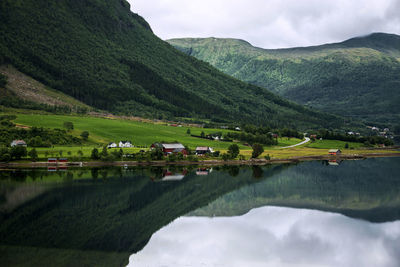 Scenic view of lake and mountains against sky