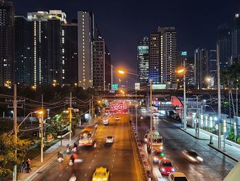 Illuminated city street and buildings at night