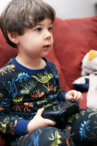 Close-up of cute girl playing in car