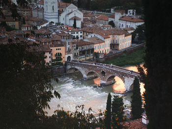 High angle view of bridge over river by buildings in city