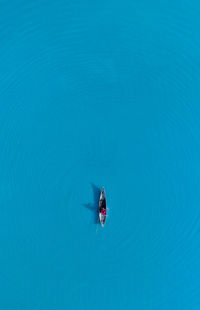 High angle view of helicopter flying over sea