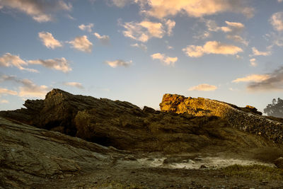 Low angle view of rock formation against sky