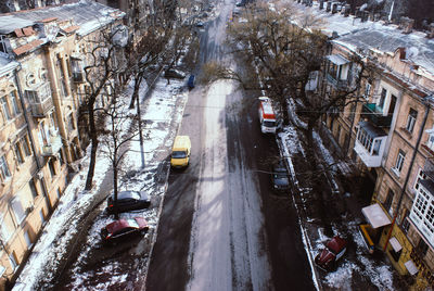 High angle view of street amidst buildings during winter