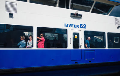 People standing by train at railroad station