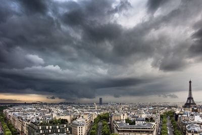 Cityscape against cloudy sky