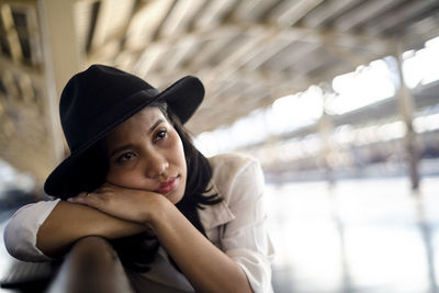 Portrait of beautiful woman sitting in hat