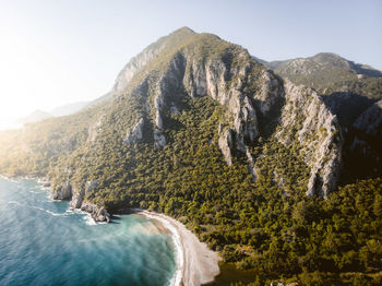 Scenic aerial view of bay with rocky mountain covered with green trees