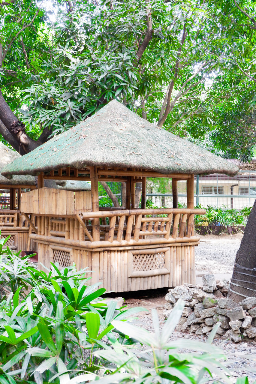 EXTERIOR OF HOUSE BY TREES IN FOREST