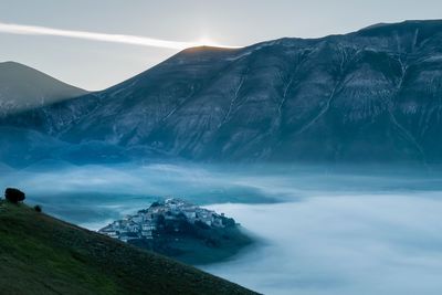 Scenic view of mountains against sky during foggy weather