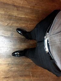 Low section of man wearing shoes