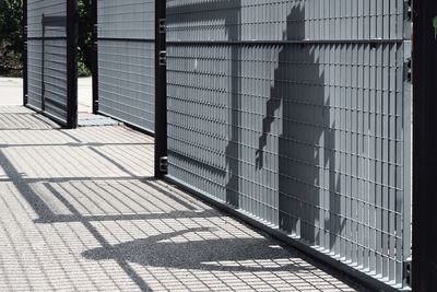 Shadow of person on metallic gate