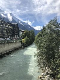 Scenic view of river amidst trees against sky