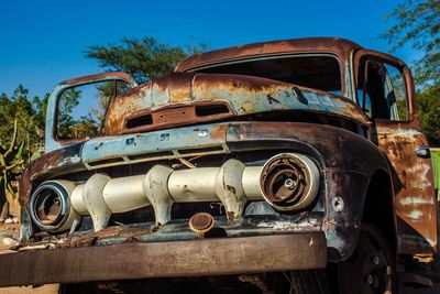 Old rusty car against sky