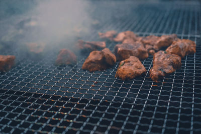 High angle view of meat on barbecue grill