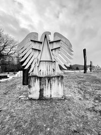 Built structure on field against sky