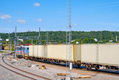 Train on railroad track against sky