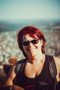 Portrait of woman wearing sunglasses against sky