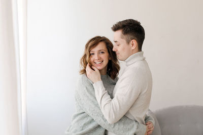 Portrait of couple embracing at home