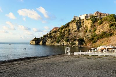 Scenic view of sea and mountains against sky