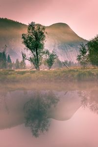 Scenic view of lake against sky at sunset