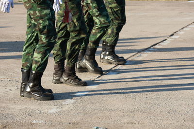 Low section of soldiers walking on street