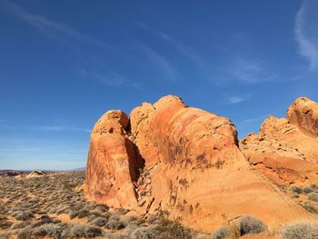 Low angle view of rock formation against sky