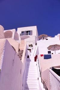 Low angle view of buildings against clear blue sky