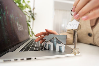 Cropped hand of man using laptop