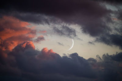 Low angle view of moon against sky at sunset