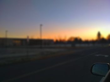 Close-up of road against clear sky during sunset
