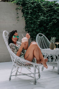 Woman sitting on chair in yard