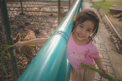 Little girl feeding wild deer animal
