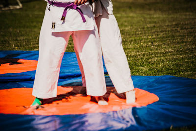 Low section of woman standing on field