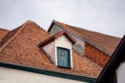 Low angle view of house roof against sky