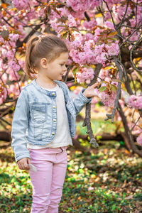 Portrait of boy standing by tree