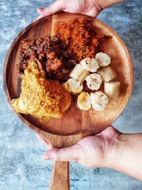 Directly above shot of person holding food in plate